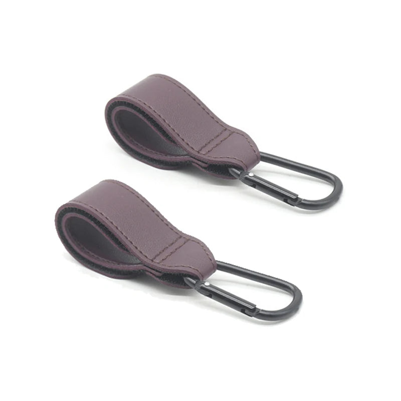 Lot de deux attaches couleur prune apportant une note elegante a la poussette.