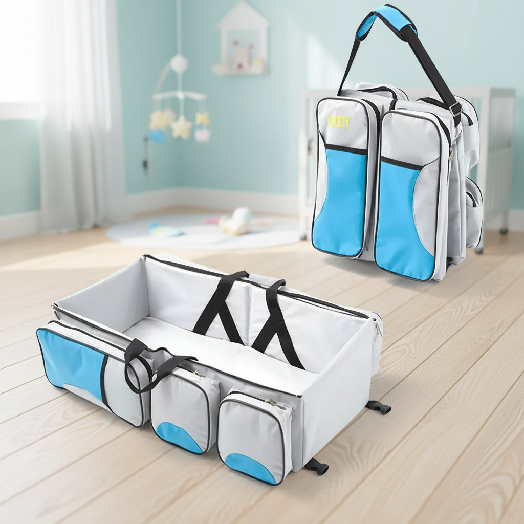 Sac a langer convertible en lit nomade coloris bleu et gris, ideal pour les sorties et deplacements avec bebe.