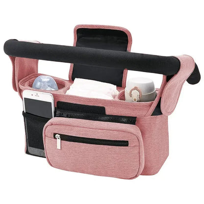 Version rose poudre de l'organisateur, avec poche zippee frontale et rangement pour telephone sur le cote.