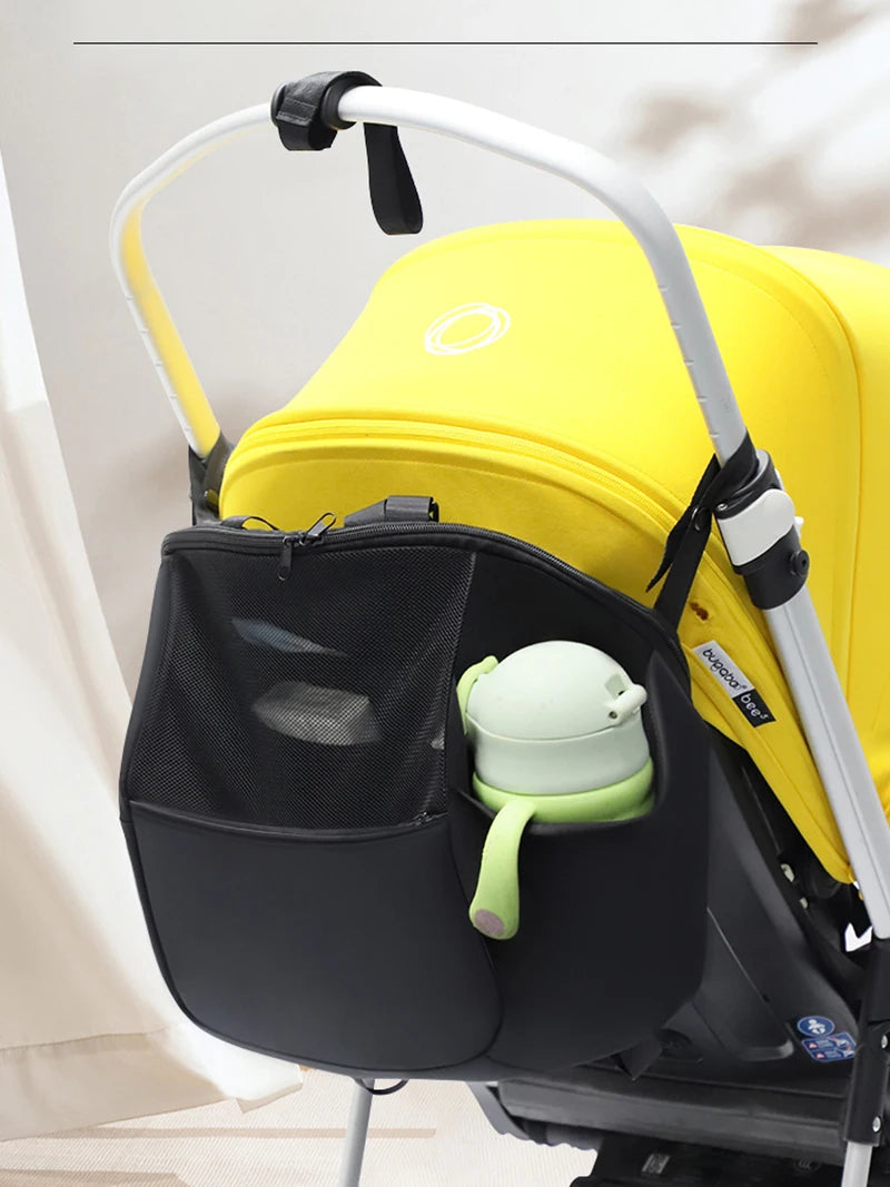 Poche laterale en filet gardant le biberon de bebe accessible et bien maintenu pendant la promenade.