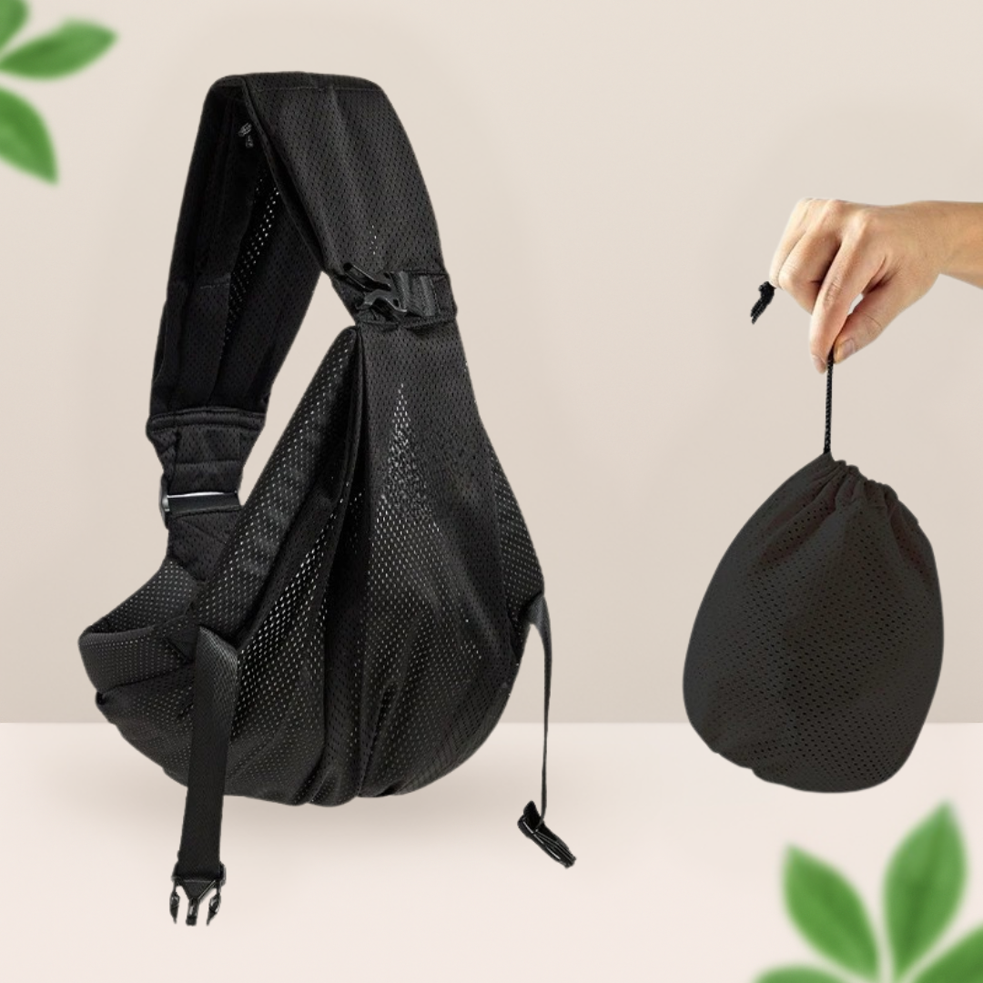 Porte-bebe sling noir en tissu respirant a cote de son etui de rangement leger, facile a emporter partout.