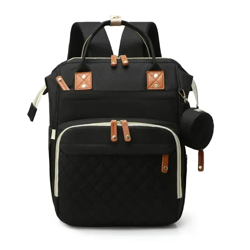 Sac a dos a langer avec lit en noir sobre et chic, parfait pour les parents qui aiment la discretion et la polyvalence.