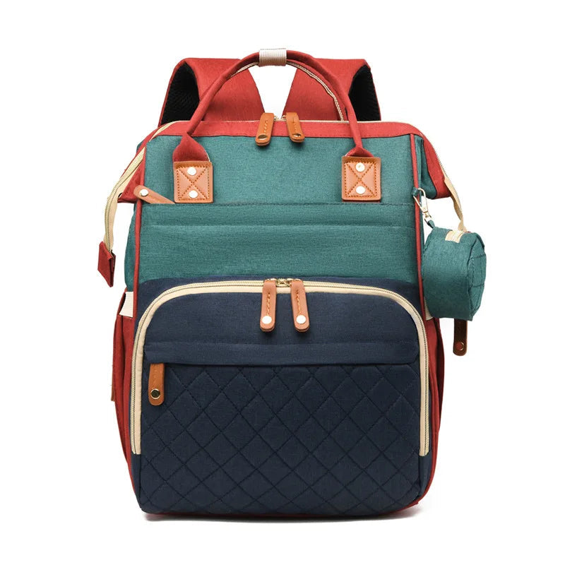 Sac a dos a langer avec lit en version tricolore originale melant rouge, vert et bleu pour un look mode et joyeux.