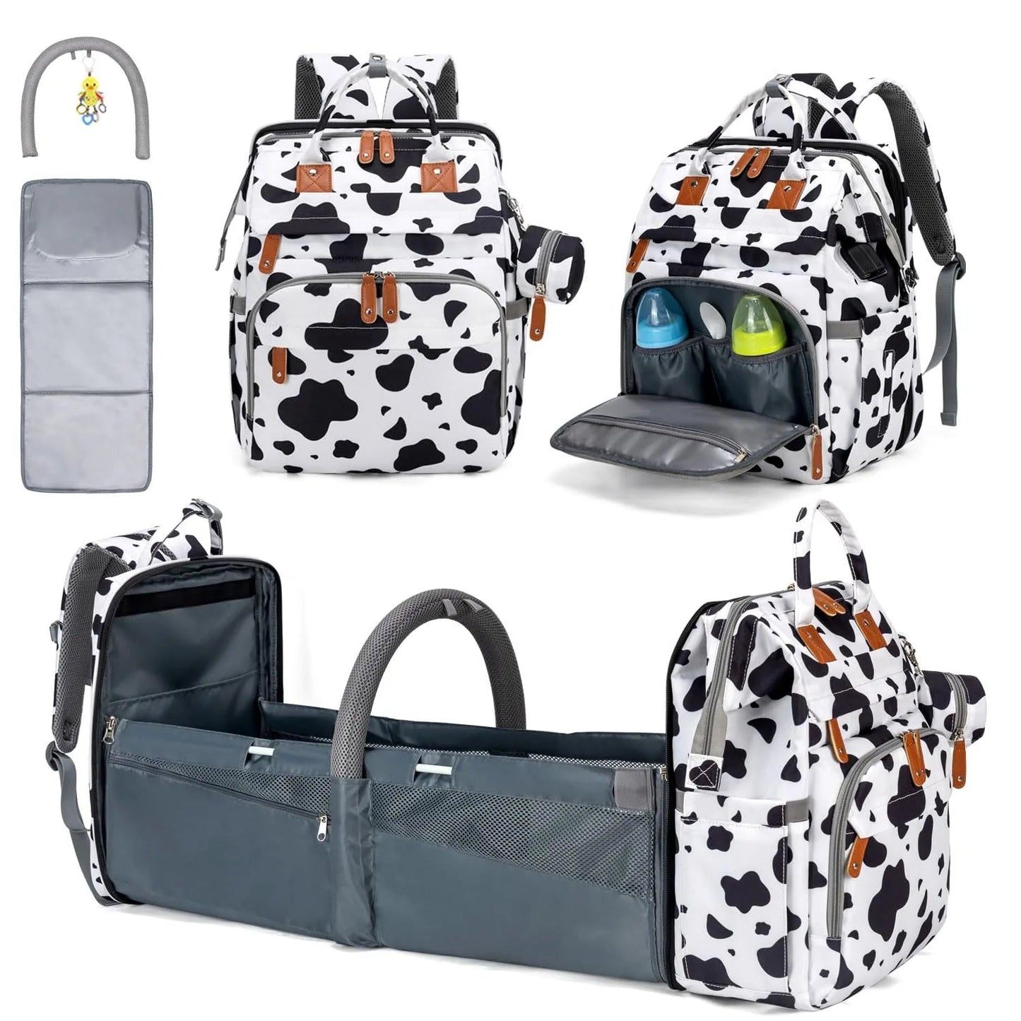 Sac a dos a langer motif vache avec lit bebe integre, matelas a langer et arche de jeu fournis pour un ensemble complet.