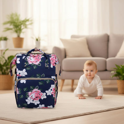 Sac a dos a langer bleu marine a motif floral, teinte foncee qui masque les traces d'usage au fil des balades.