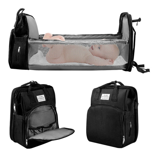 Sac a dos a langer transformable en lit bebe pliable, presente ouvert et ferme sous plusieurs angles avec table a langer integree.