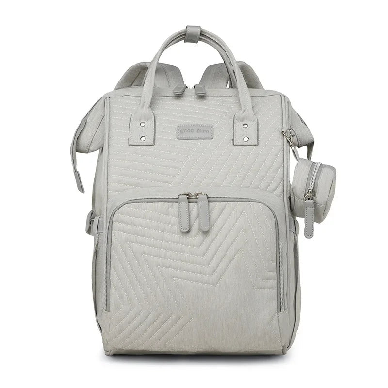 Sac a langer a dos beige ecru au style epure, ideal pour les parents en quete de sobriete.
