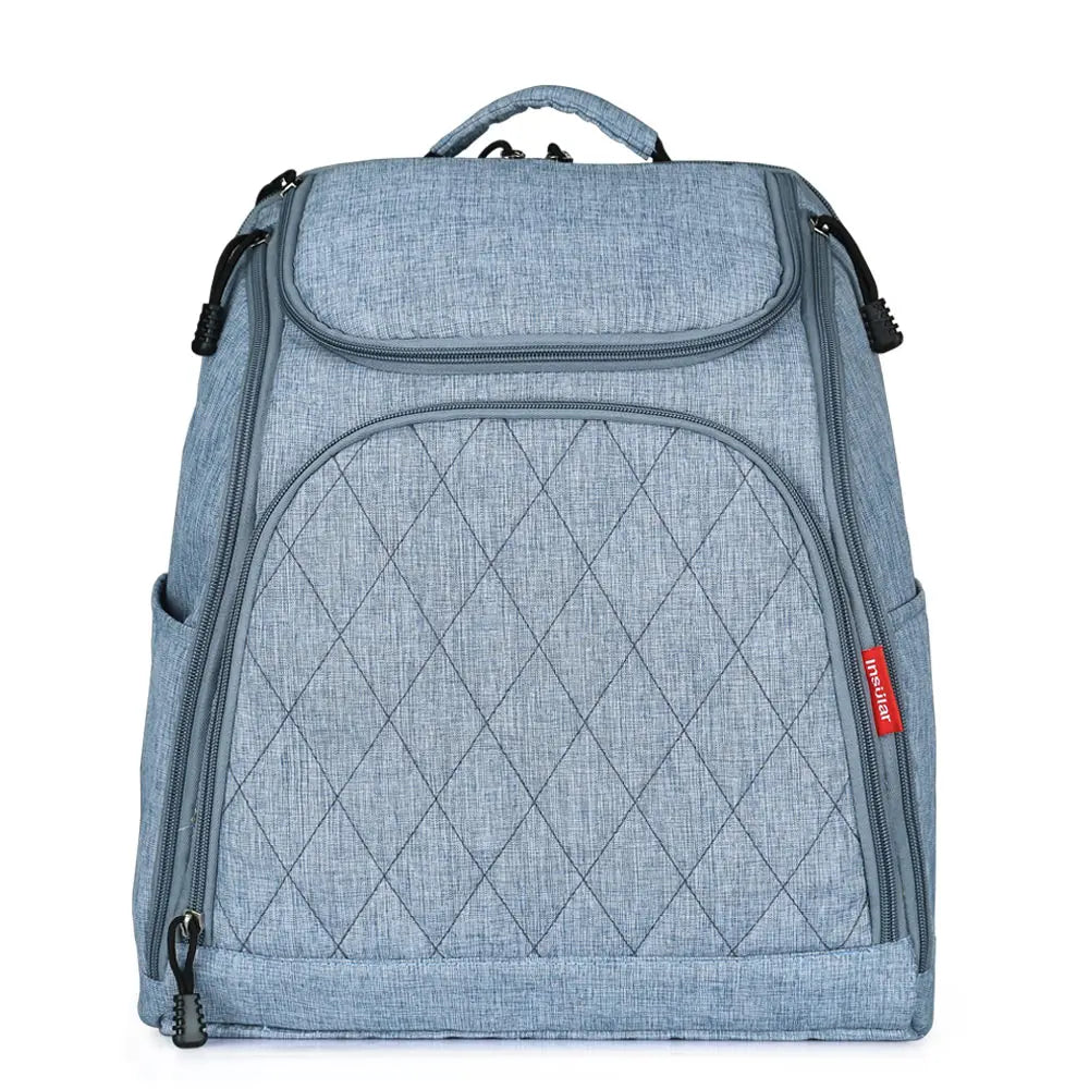 Sac a langer a dos en coloris bleu denim avec poches laterales, presente de face pour montrer sa finition elegante.