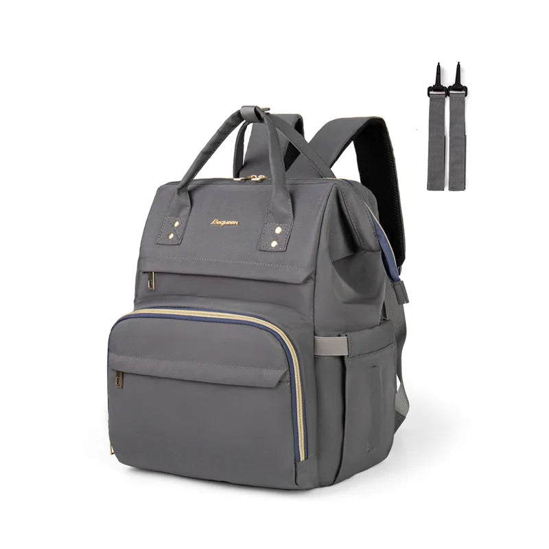 Sac a langer gris fonce presente avec ses accessoires de fixation, offrant un style discret et polyvalent au quotidien.