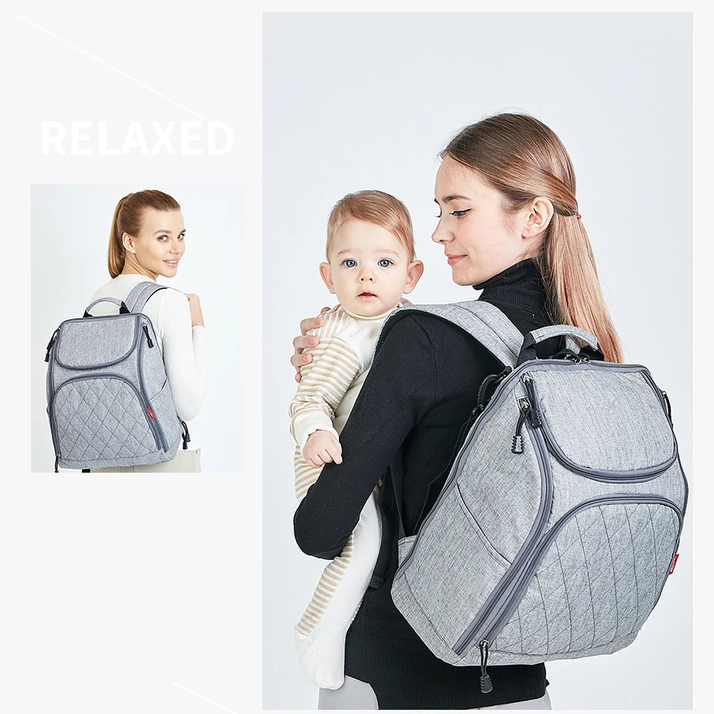 Maman detendue portant le sac a dos tout en tenant son enfant, soulignant le confort du portage au dos.