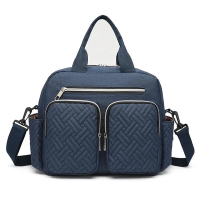 Sac a langer bandouliere en coloris bleu marine avec bandouliere reglable, un style sobre qui accompagne les parents en toutes occasions.