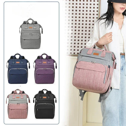 Nuancier des cinq coloris du sac a langer convertible : gris, bleu, violet, rose et noir pour tous les gouts.