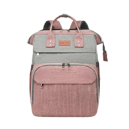 Sac a langer convertible bicolore rose et gris presente de face avec ses poignees renforcees, ideal pour les jeunes parents en deplacement.