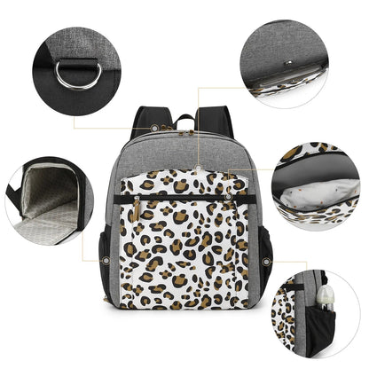 Schema detaille du sac a langer leopard mettant en avant l'anneau metallique, le matelas a langer integre et les rangements isothermes.