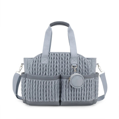 Sac a langer gris avec multiples poches frontales et petite pochette ronde detachable pour les accessoires