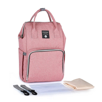 Sac a langer rose Insular livre avec ses sangles poussette, son tapis a langer et sa pochette impermeable pour tout emporter.