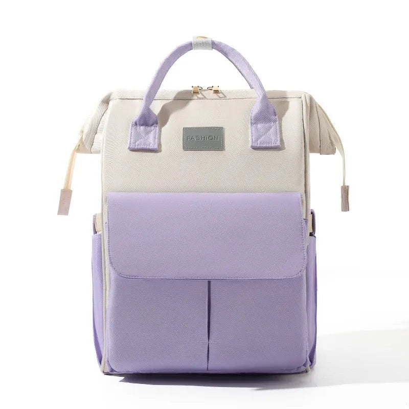 Sac a dos a langer bicolore blanc et mauve, une touche coloree pour un accessoire de puericulture tendance.