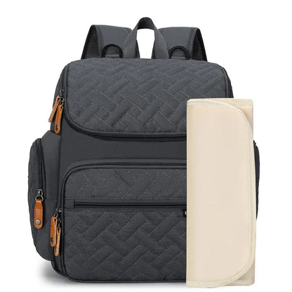 Sac a langer sac a dos en coloris gris anthracite accompagne de son matelas a langer pliable inclus.
