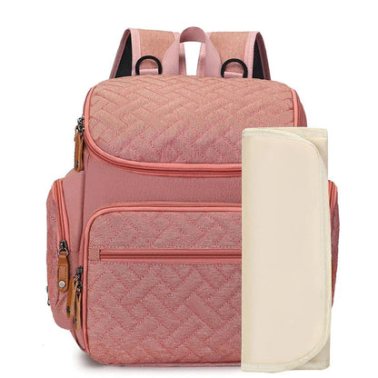 Sac a dos a langer rose poudre au style feminin et delicat, livre avec son tapis a langer assorti.