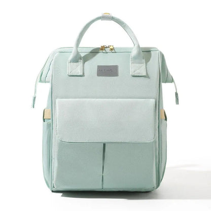 Sac a dos a langer en coloris vert menthe pastel, design elegant et discret pour les sorties avec bebe.