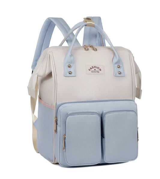Sac a langer a dos coloris bleu pastel et ecru avec doubles poches frontales, ideal pour ranger biberons et affaires de bebe lors des sorties.