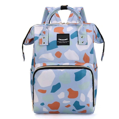 Sac a langer sac a dos au motif terrazzo bleu avec grande poche zippee frontale, ideal pour transporter les affaires de bebe avec style.